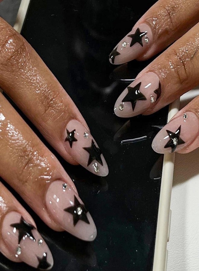 Maigitur Black Star Press on Nails Medium Almond Fake Nails with Design Rhinestone Stick on Nails Acrylic Nail Star False Nail Glossy Natural Nude Glue on Nail for Women Girls Manicure 24Pcs… - Image 1